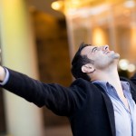 Successful businessman with arms up celebrating his victory