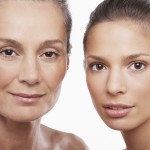 Closeup portrait of two women of different ages on white backgro