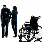 one  man with woman  walking away from  wheelchair  in silhouett